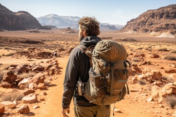 Fototapeta na wymiar Adventurer exploring a remote desert landscape - stock photography concepts
