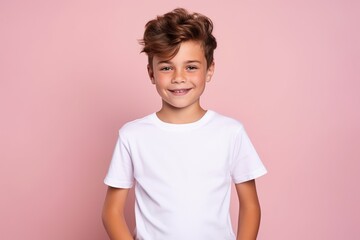 Young boy wearing white blank t-shirt on pink background, t-shirt template, mockup, studio shot, child wearing shirt