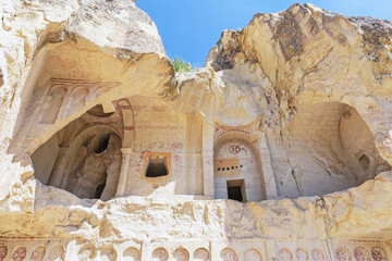 Entrance to the Dark church in volcanic landscape at Goreme Open air museum. Mediaeval monastery on...
