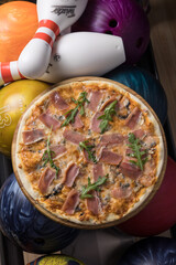Delicious pizza with meat in a bowling club