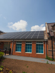 Newly fitted solar panels on the roof of an old school building
