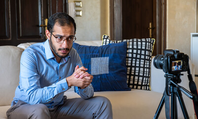 Young arabic man conducting a seminar from home