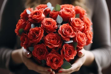 Fototapeten Person holding a heart-shaped bouquet of red roses - stock photography concepts © 4kclips