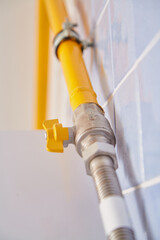 Yellow natural gas supply pipe close up