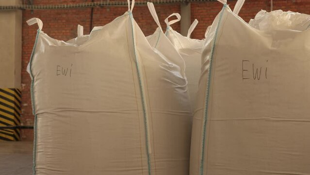 Industrial containers, Container filling, Product distribution. Myriad bags of products or raw materials occupy space within industrial plant.