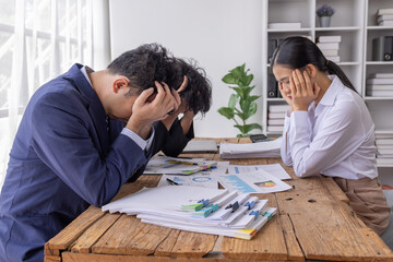 Stressed asian young Business team thinking of problem solution at emergency office meeting, sad...