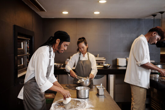 Bakery workers making dough and toppings for pies