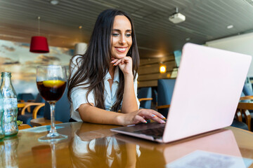 Business woman working in airport lounge.