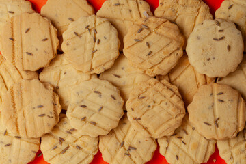 Closeup of a group of assorted carom seeds cookies or salted ajwain cookies. Top view wallpaper.