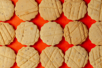 Closeup of a group of assorted carom seeds cookies or salted ajwain cookies. Top view wallpaper.