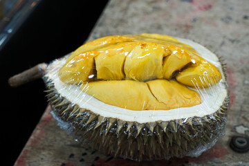 Open durian, wrapped, for display at a durian stall.