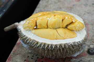 Open durian, wrapped, for display at a durian stall.