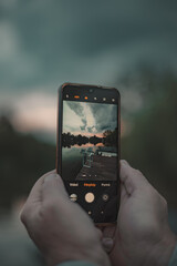 hand holding a phone and take a picture