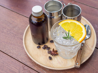 ice in a glass and coffee in a bottle
