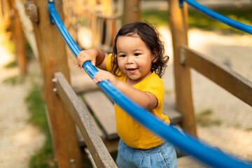 Adorable Asian Toddler Baby Girl Playing Alone On Playground Outside
