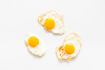 Fried eggs pattern on white background, top view. Breakfast concept
