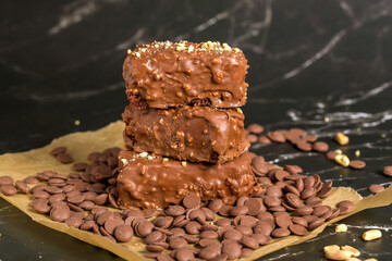 Chocolate sticks with peanuts on a dark background