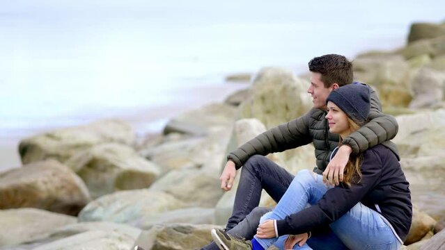 Young couple relaxing at a rocky beach - travel Ireland photography clip 