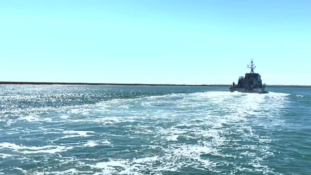 A patrol ship sails across the Atlantic Ocean near the Algarve coastline in Portugal. Drone flight