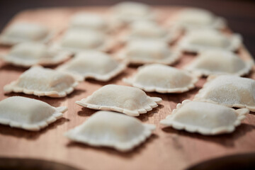raw dumplings on teh wooden board