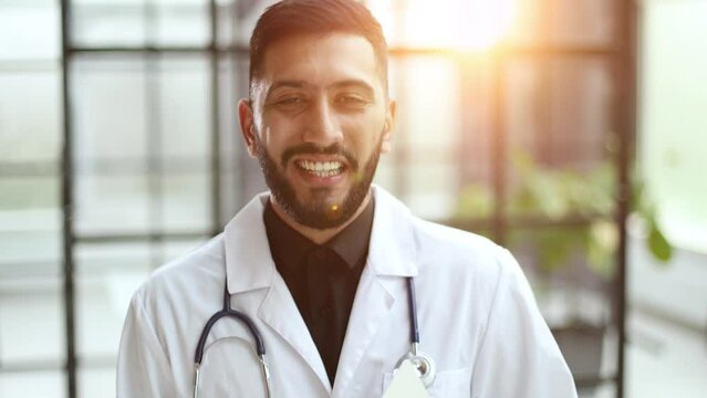 man wearing doctor coat with a confident expression on smart face thinking serious
