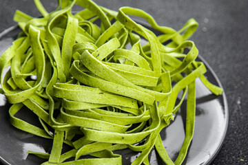 green pasta tagliatelle raw color basil vegetable food meal food snack on the table copy space food background rustic top view