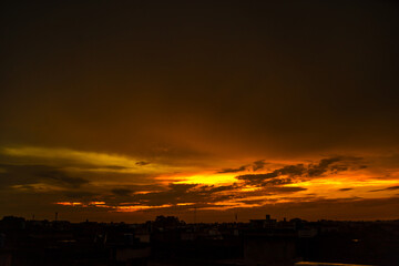 Beautiful sunset over the city with a cloudy sky