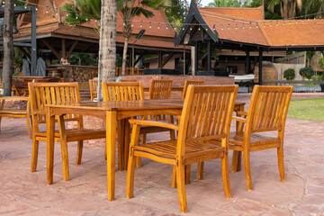 Fototapeta na wymiar outdoor restaurant at the dining table sea view on beach, wood chairs and table