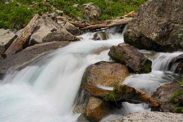 Flowing waterfall in deep forest mountain taken in low shutter speed.