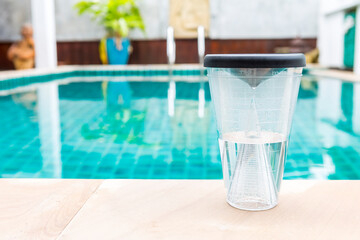 Analogue rain gauge on swimming pool edge, measure rainfall at home, tool for garden and agricultre use