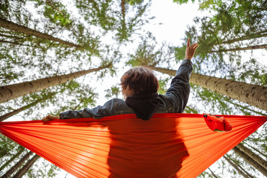 happy woman on hammock in the forest