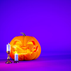Jack o lantern and candles on purple Halloween background with copy space
