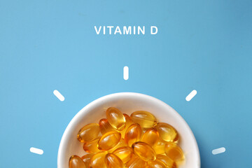 Yellow capsules in a plate, vitamin D