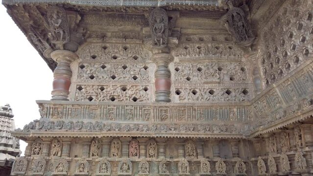 Belur, Karnataka, India-June 17 2023; A Tilt view of exquisite carvings of patterns and deities and animals on a stone temple exterior built in 12th century at Belur near Hassan in Karnataka, India.
