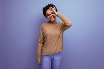 young positive hispanic lady with afro curly hair smiling on background with copy space