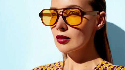 Square shape yellow sunglasses fashion model portrait. Young beautiful model posing in vintage...