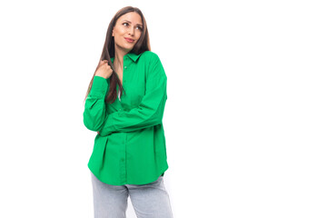 attractive sexy young caucasian brunette lady with makeup dressed in an elegant green shirt on a white background with copy space