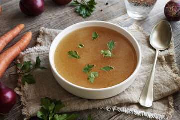 Chicken and vegetable broth or soup on a table