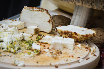 Fresh smoked cheese with spices for sale in grocery shop