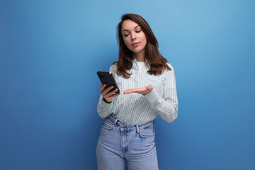 well-groomed 25 year old brown-haired woman communicates using an online application on her phone