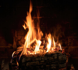 Fireplace close up, fire flame and burning wood log, warm home in winter