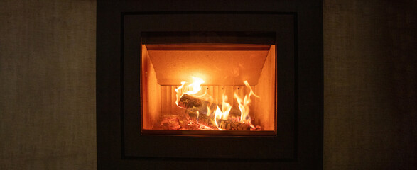 Energy fireplace on a wall, fire flames and burning wood logs in a stove
