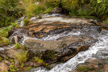 Naklejka na ściany i meble cascade on creek in the mountains