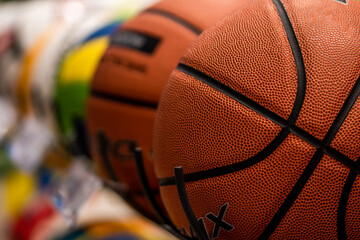 Basketballs on the rack of sports retail store, in sports shop.