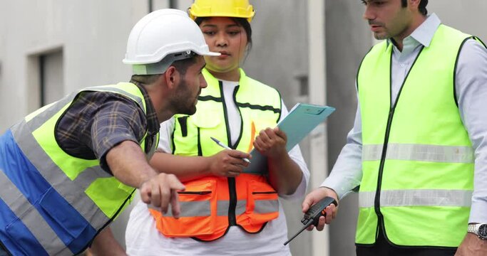 Obese female and hispanic male site engineers. Ethnic diversity worker people, Success teamwork professional engineering people in hardhat safety helmet meeting at Prefabricated concrete walls factory