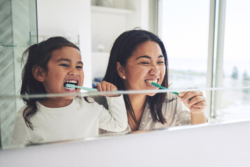 Mother, child and brushing teeth in morning routine, dental hygiene or healthcare together by...
