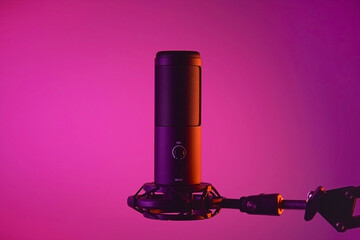 Studio condenser microphone isolated on dark background.