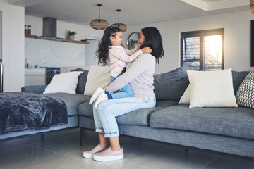 Fototapeta premium Relax, happy and playful with mother and daughter on sofa for love, care and support. Funny, calm and smile with woman and young girl embrace in living room of family home for peace, cute and bonding