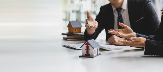 Real estate agent business people discussing the budget of a house project. The real estate agent is explaining the details of the terms of the house and land purchase agreement.
