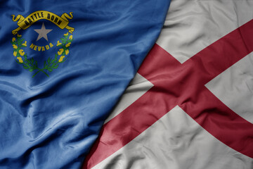 big waving colorful national flag of alabama state and flag of nevada state .